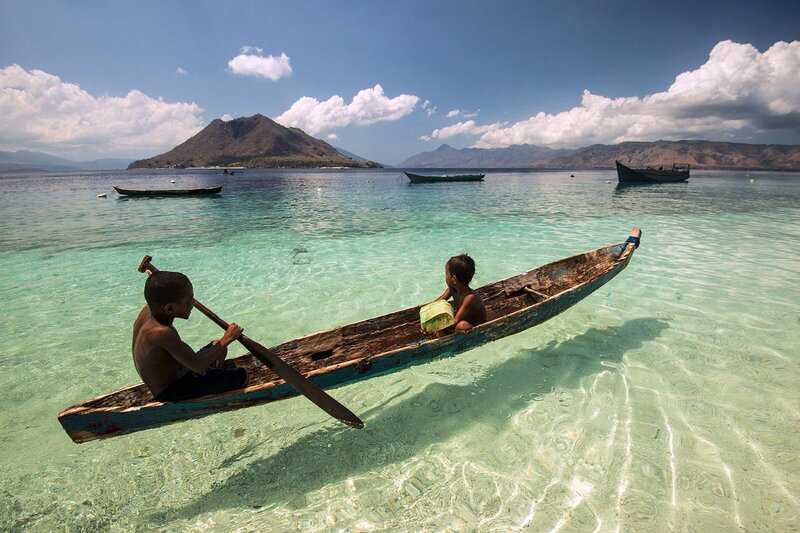 Two children in a traditional vessel in Alor, Indonesia