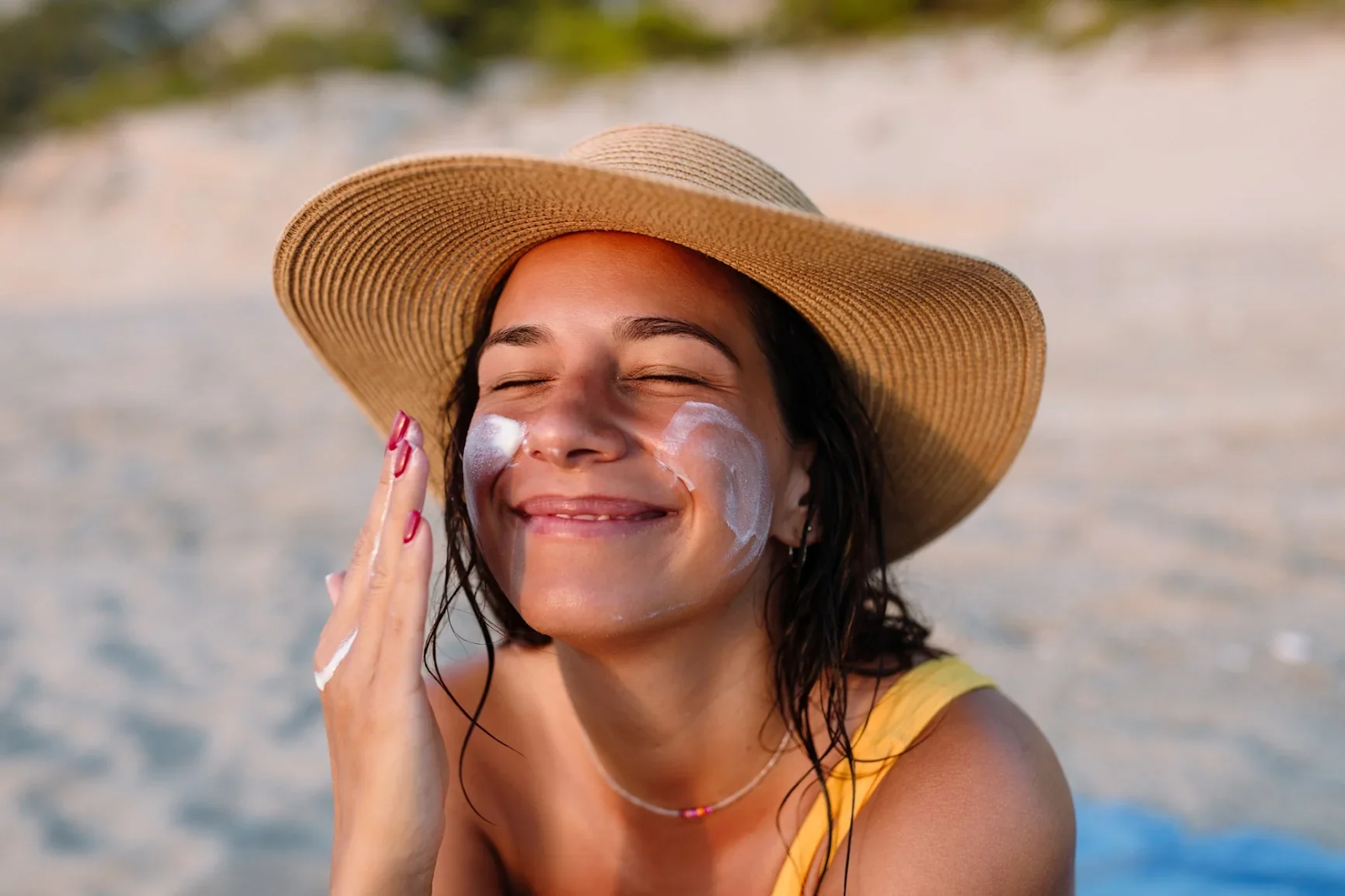 A woman applying sunscreen